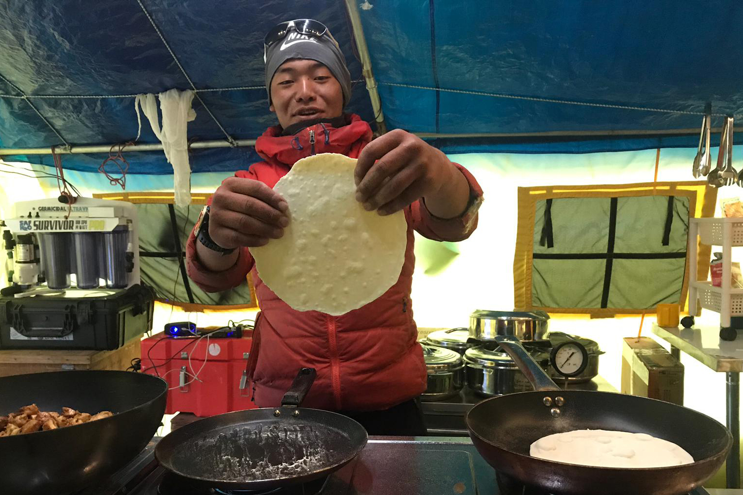 AC Assistant Cook Tenjing Sherpa makes chapati flatbread at Everest Base Camp